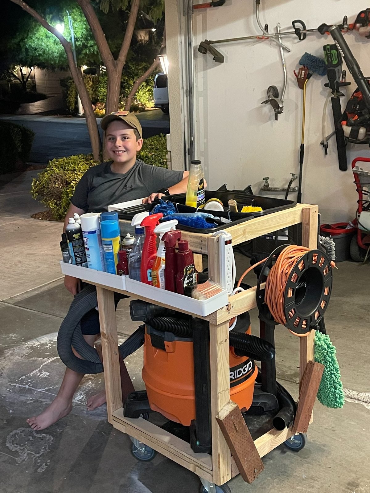 A young Dagger Shine founder with his hand-built wooden detailing cart